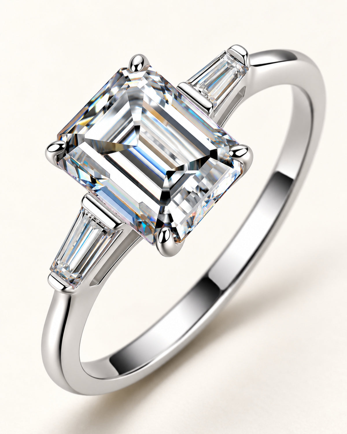Macro view of emerald-cut moissanite ring with tapered baguette sides