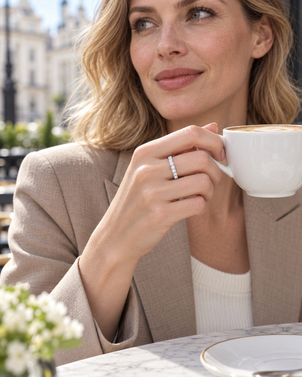 British woman wearing silver moissanite eternity ring at a London cafe