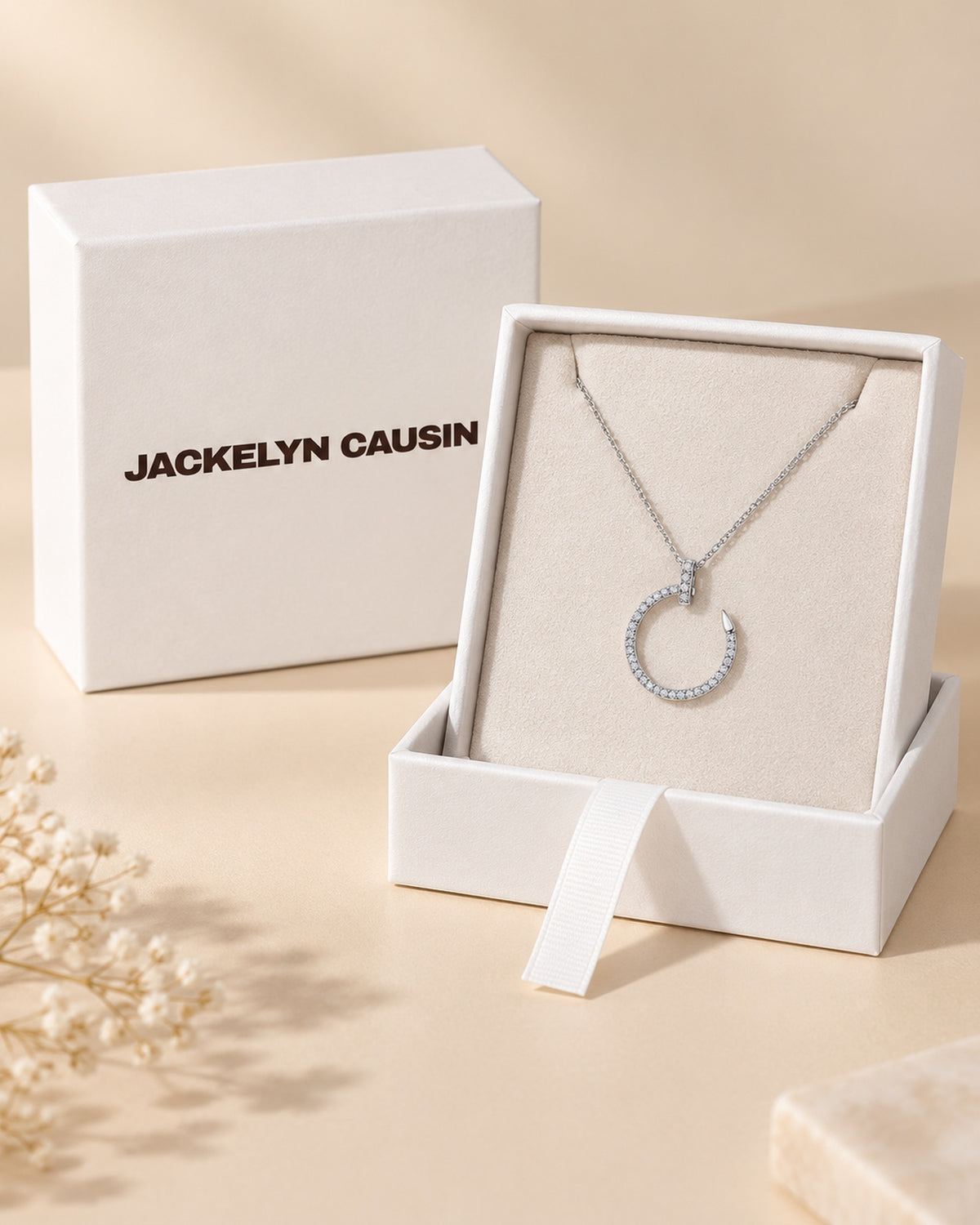 JACKELYN CAUSIN presentation packaging with moissanite crescent nail pendant necklace