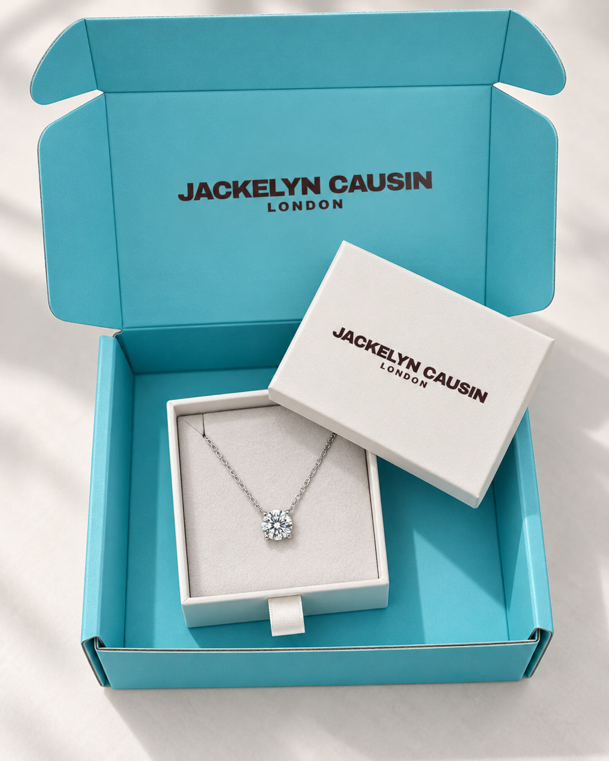 Moissanite necklace presented in Jackelyn Causin branded packaging