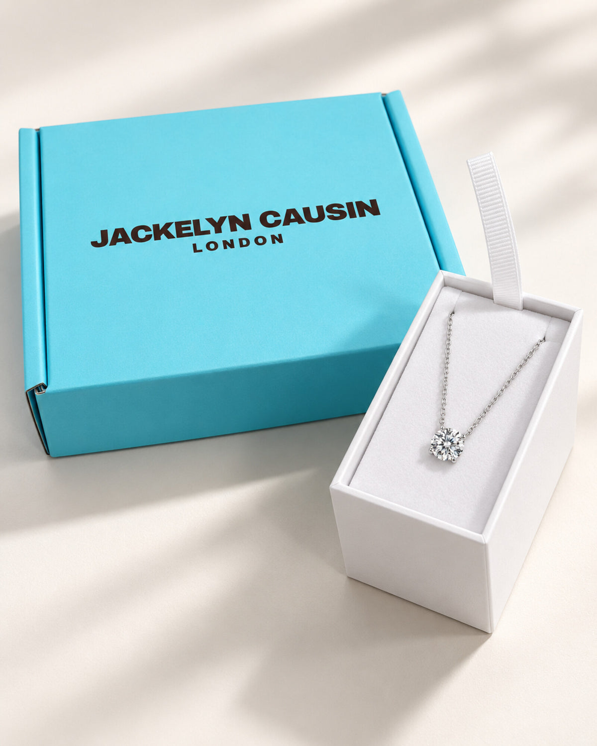 Moissanite necklace with Jackelyn Causin turquoise and white packaging