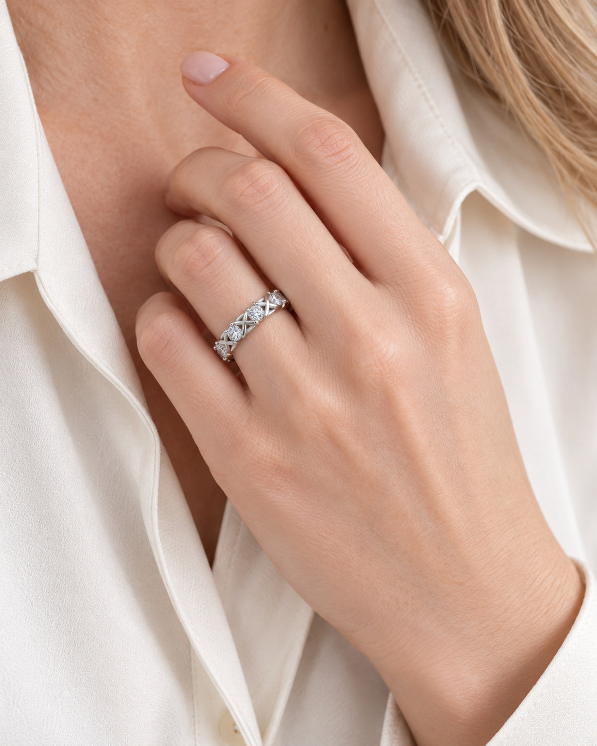 British woman wearing a silver moissanite crossover eternity ring