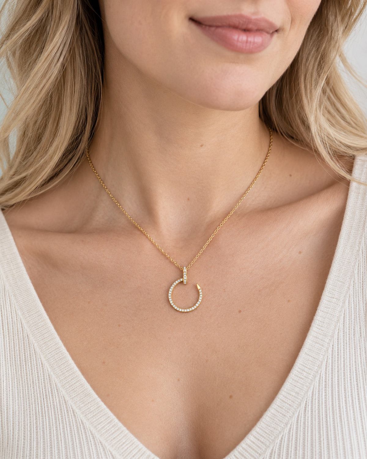 Gold tone moissanite crescent nail pendant necklace worn on model