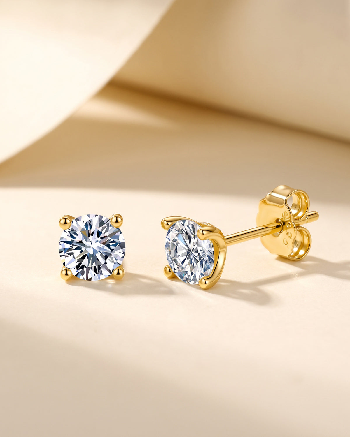 Gold-tone four-prong round moissanite stud earrings in S925 sterling silver