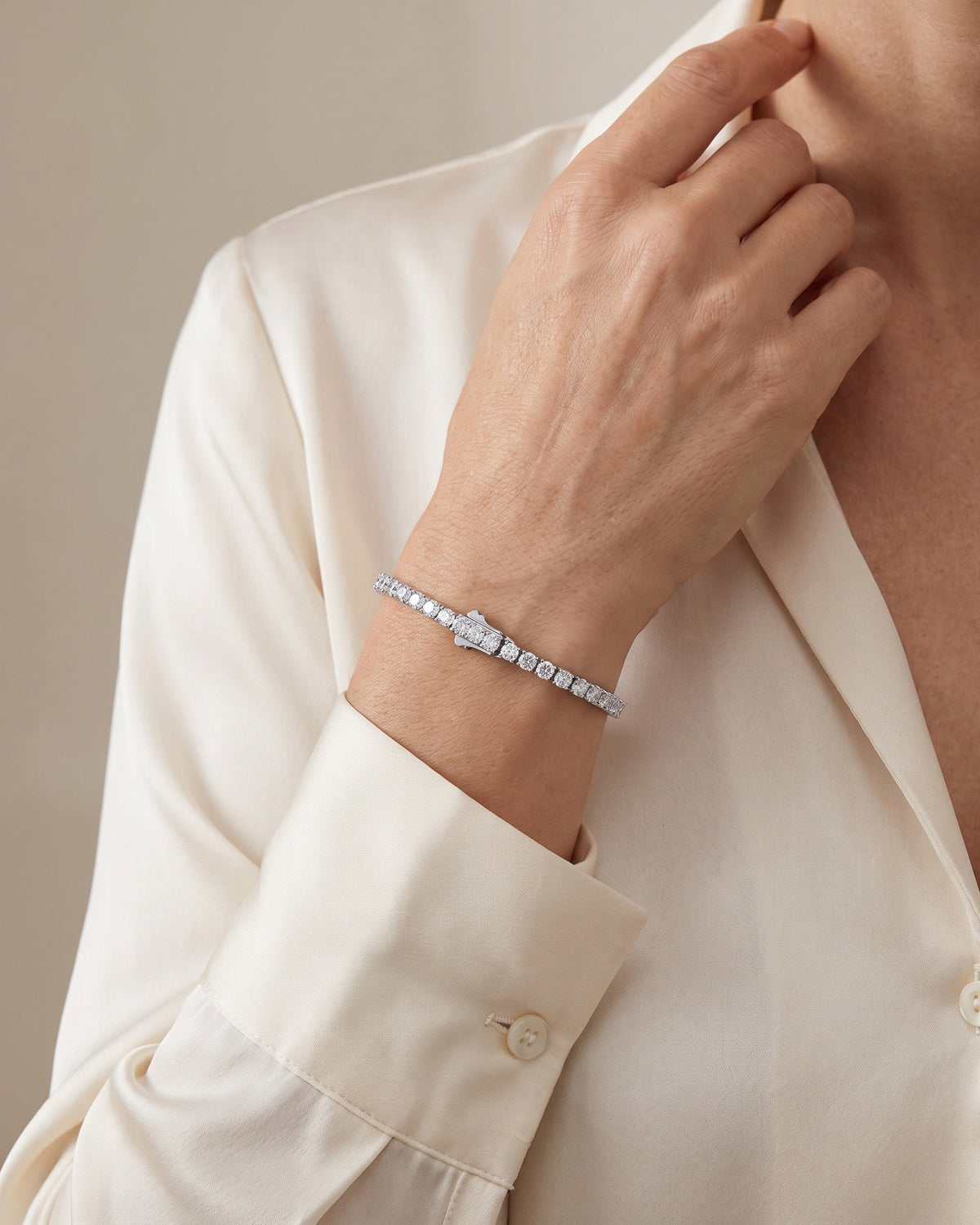 Woman wearing a silver-tone moissanite tennis bracelet