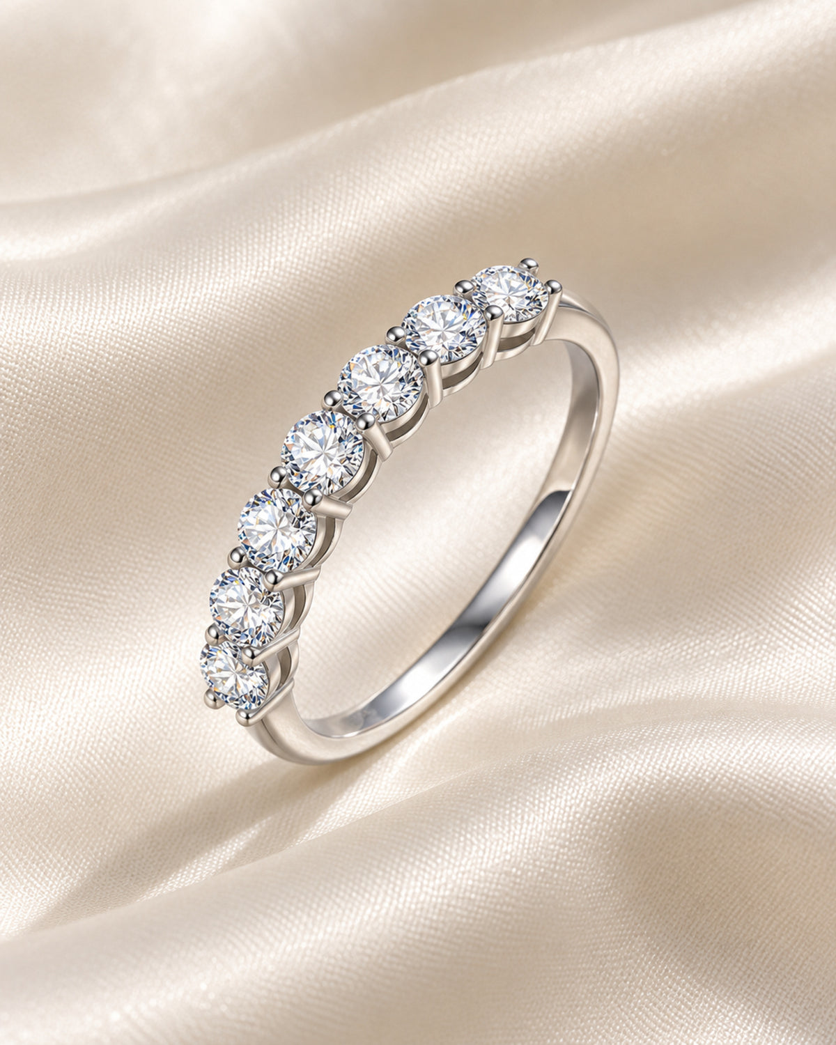 Silver tone seven-stone moissanite stacking ring on ivory silk