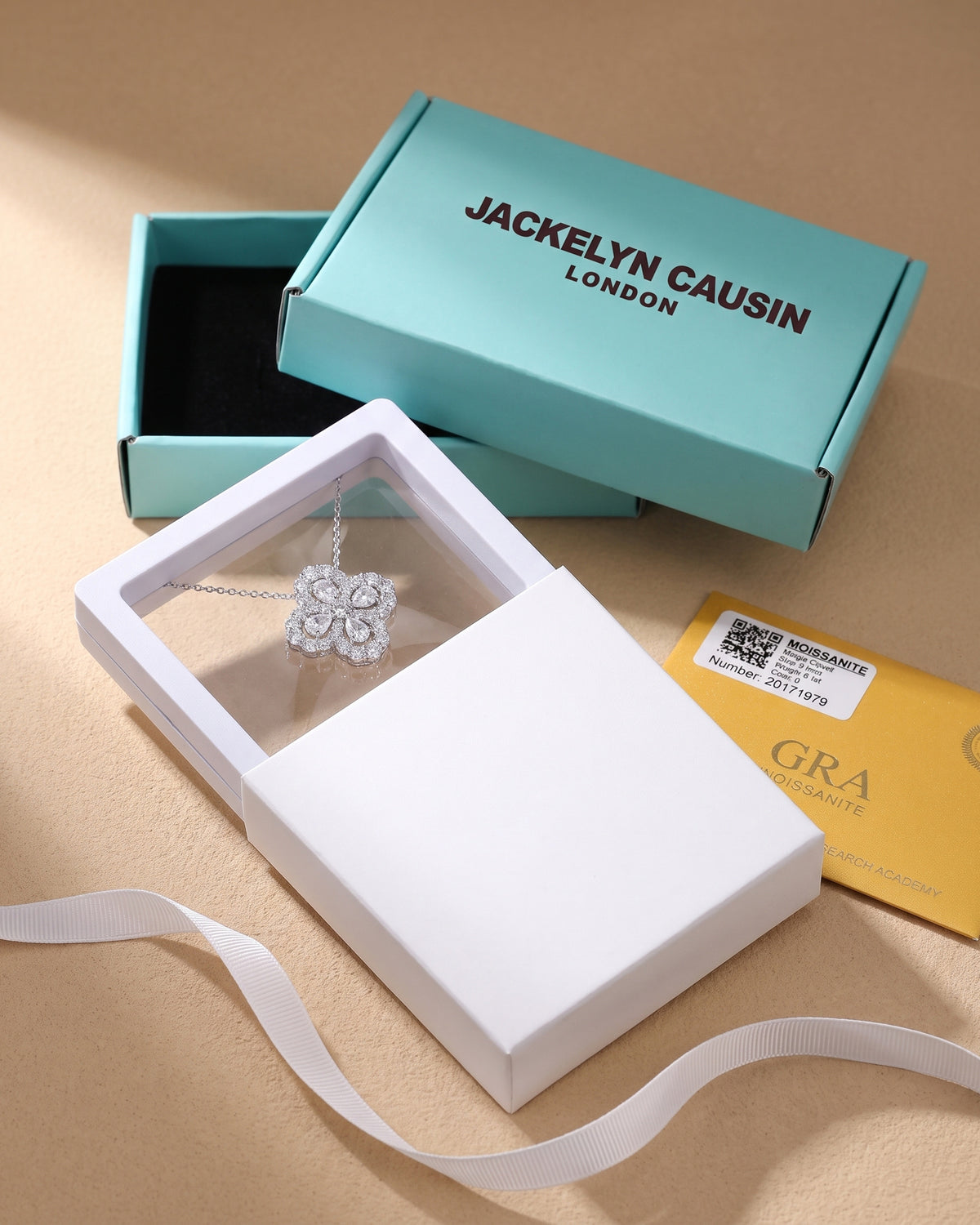 Moissanite clover necklace presented in Jackelyn Causin branded packaging