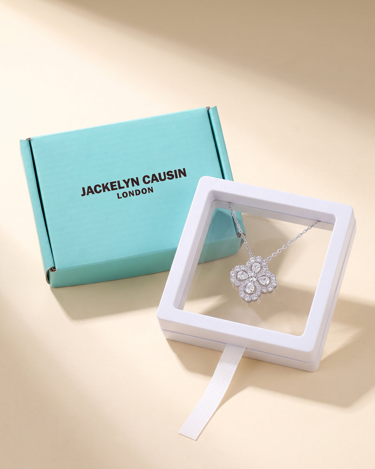 Moissanite clover necklace with Jackelyn Causin turquoise and white packaging