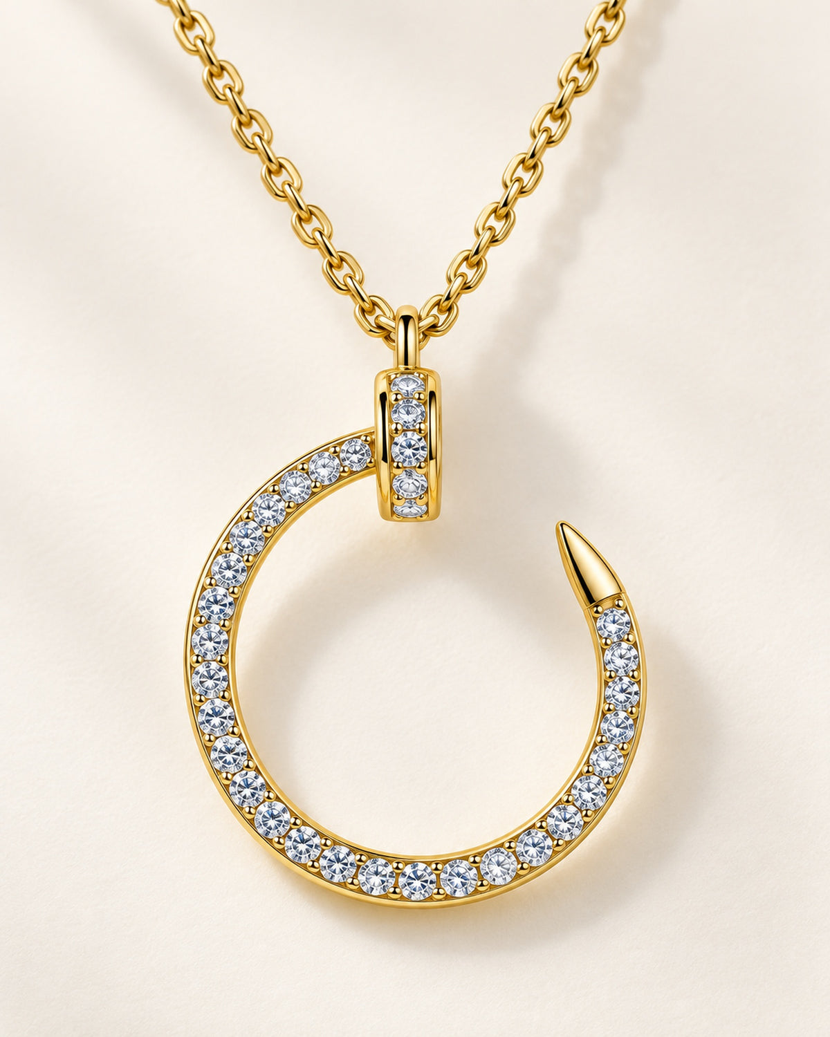 Close detail of gold tone S925 sterling silver moissanite crescent nail pendant necklace