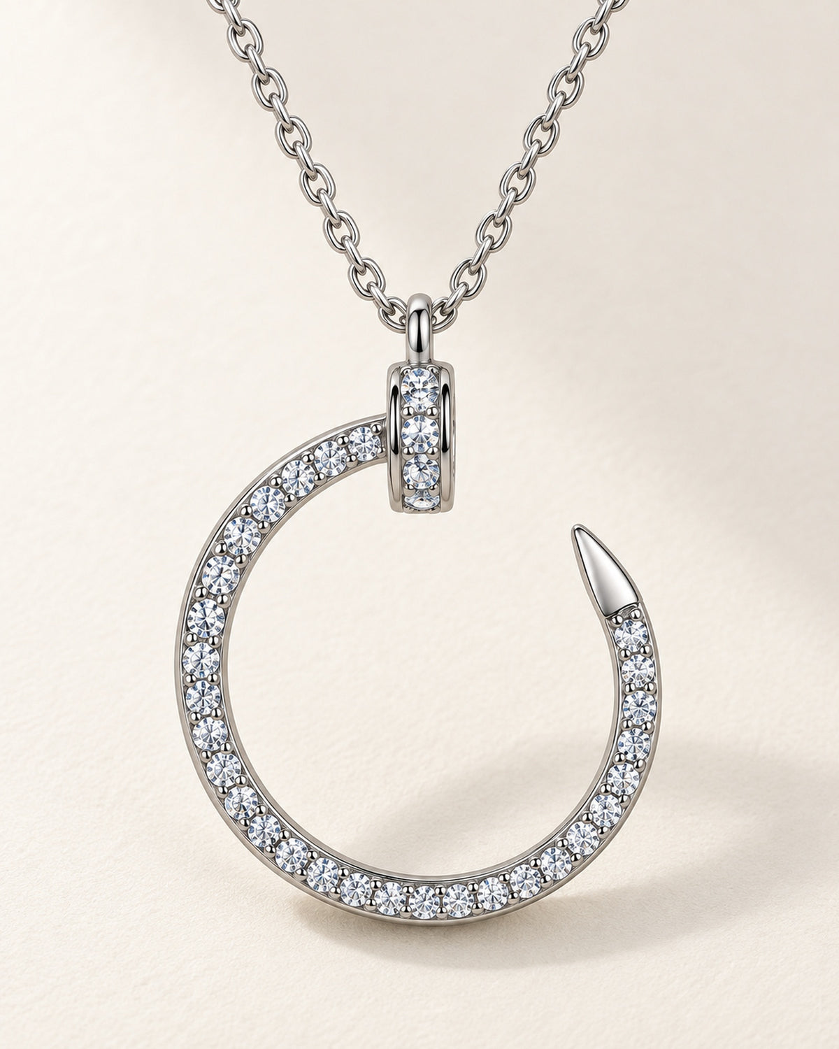 Close detail of silver tone S925 sterling silver moissanite crescent nail pendant necklace
