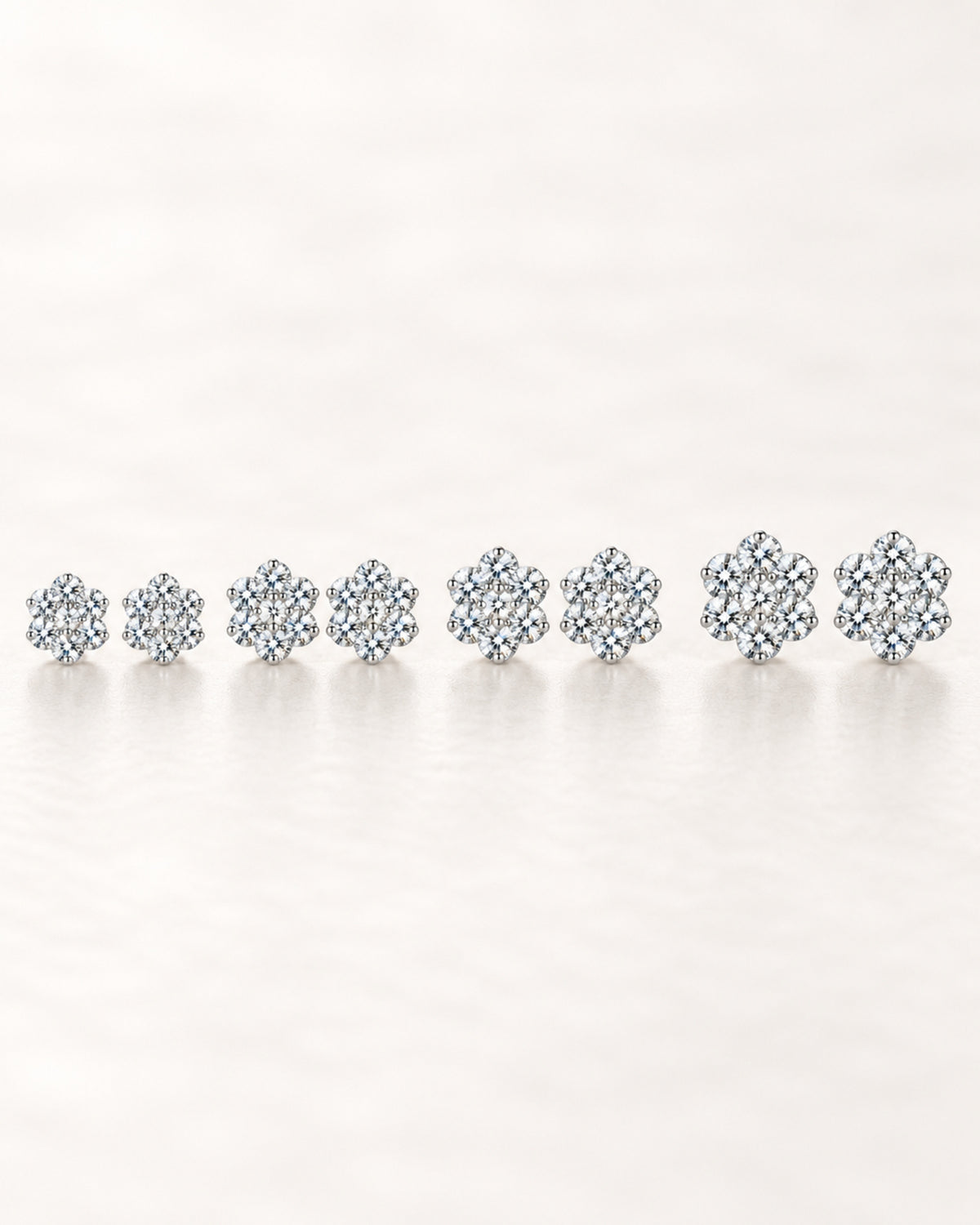 Four moissanite flower stud earring sizes from 7 to 10 mm