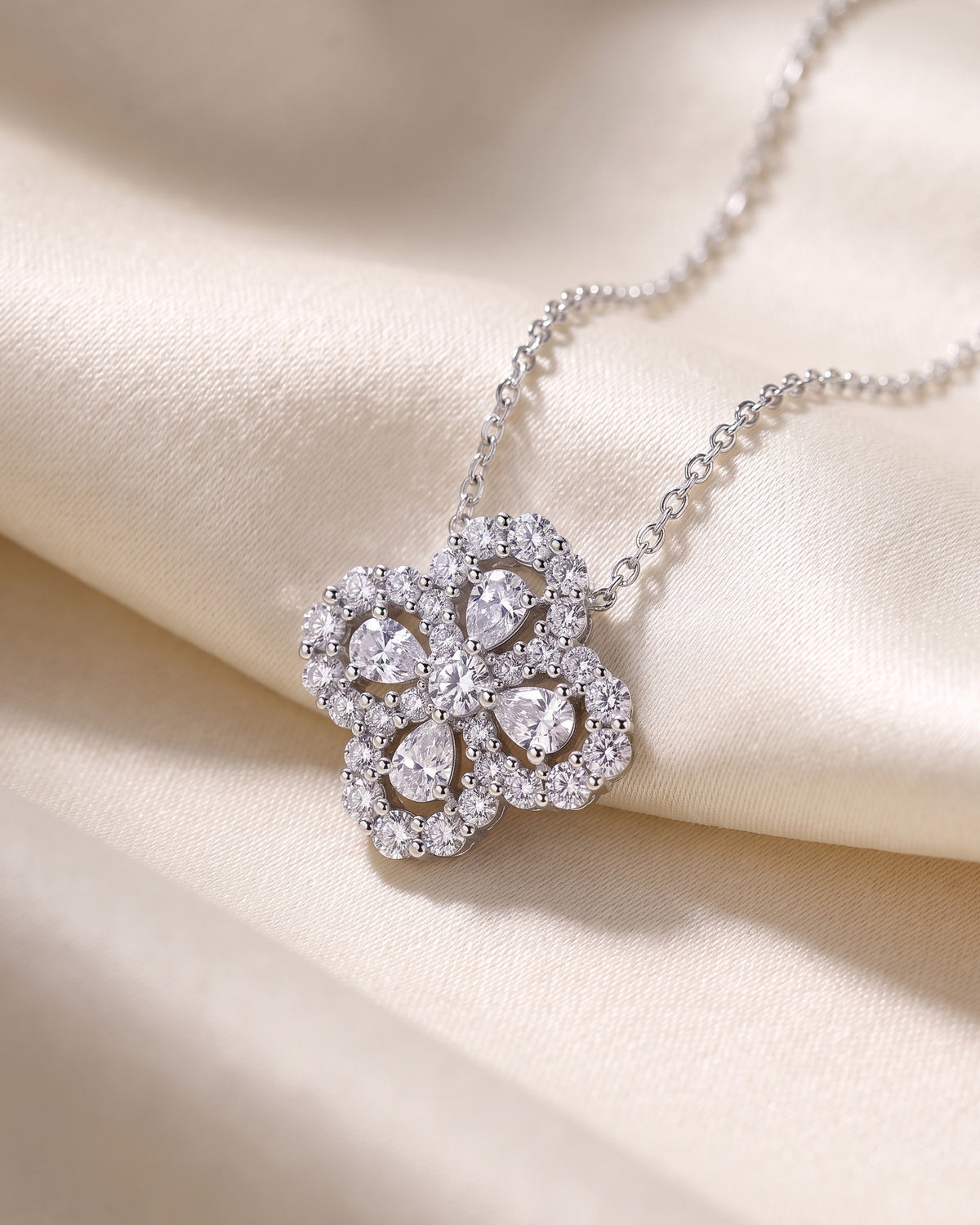 Silver-tone moissanite four-leaf clover pendant necklace on ivory silk