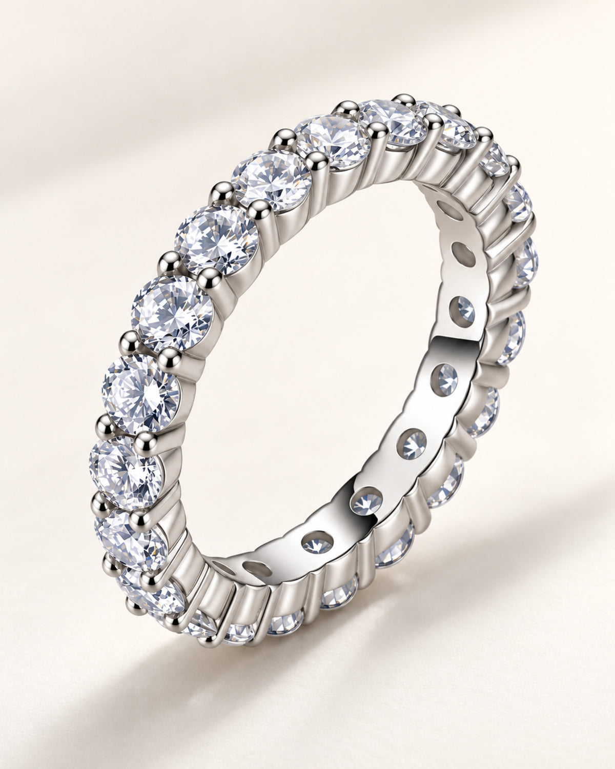 Side and gallery view of shared-prong moissanite eternity band