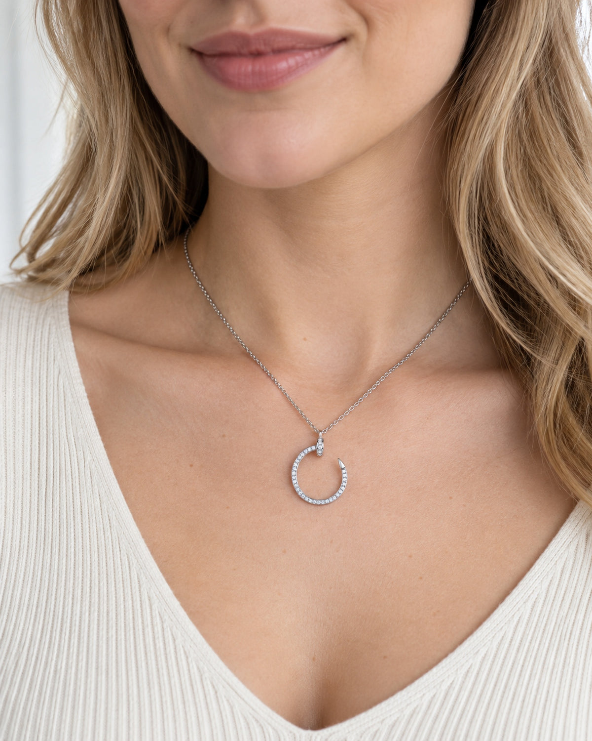 Silver tone moissanite crescent nail pendant necklace worn on model