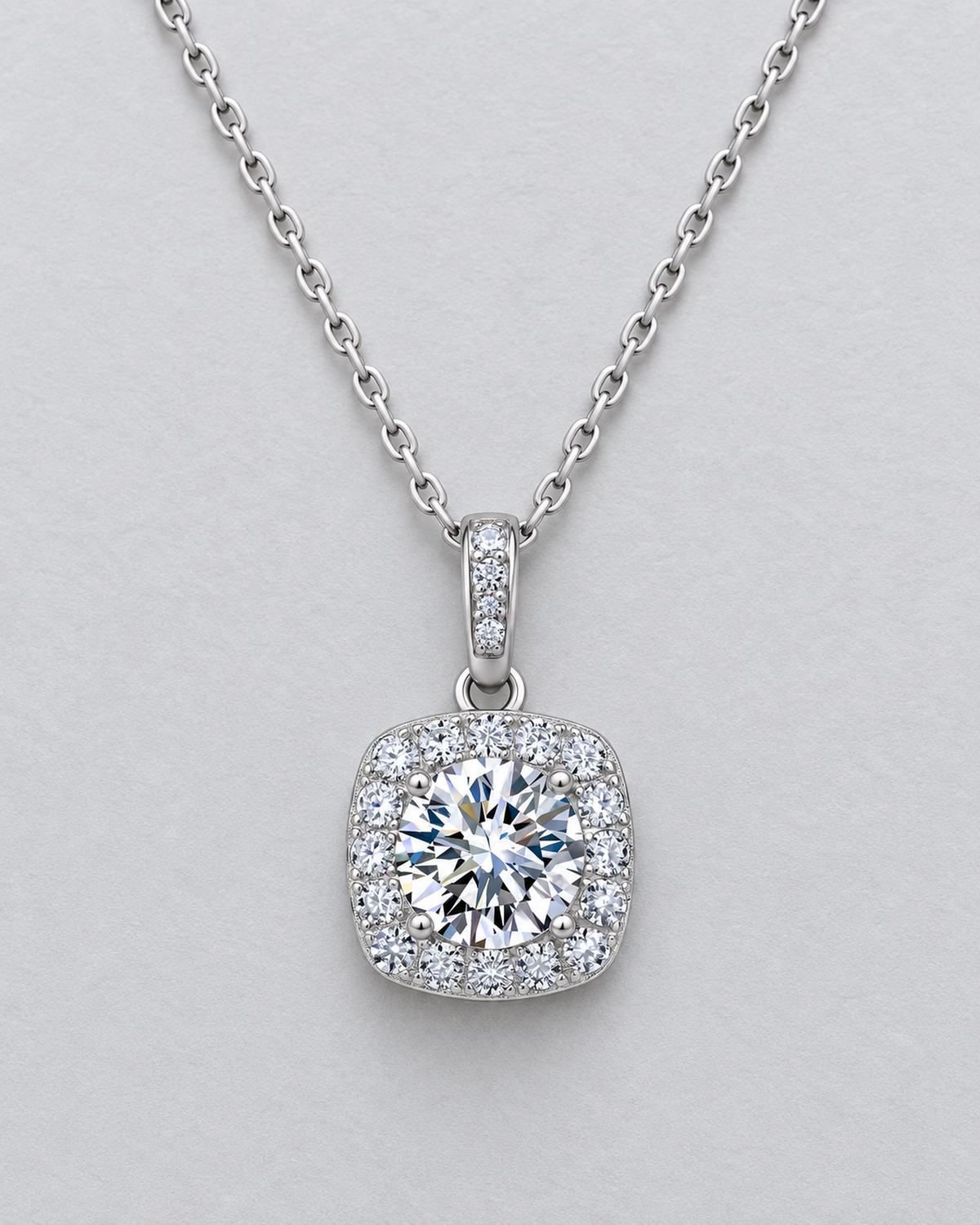 Silver-tone square halo moissanite necklace on a pale grey background
