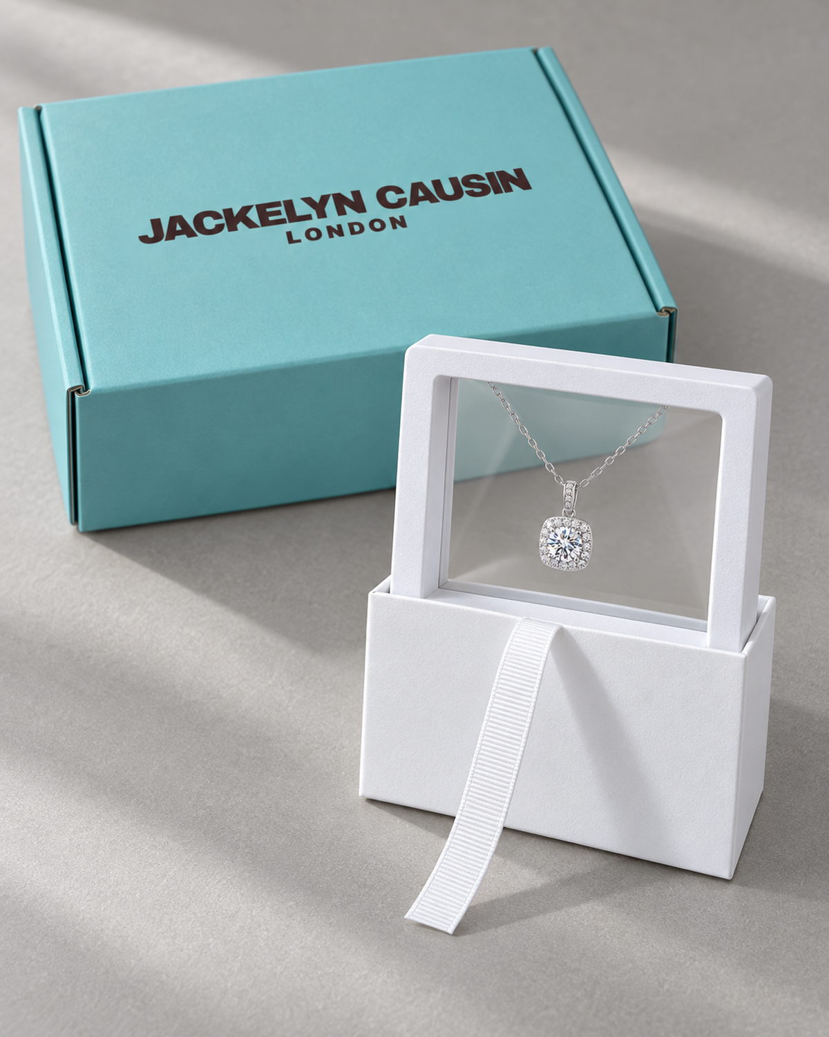 Square halo necklace in JACKELYN CAUSIN turquoise and white presentation packaging